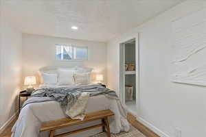 Bedroom featuring wood-type flooring and a textured ceiling