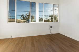 Spare room featuring wood-type flooring