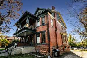 View of front of property featuring a porch and a balcony