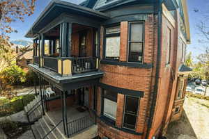 View of side of home with a balcony and a mountain view