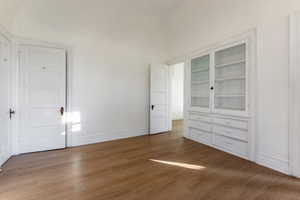 Bedroom with hardwood / wood-style flooring