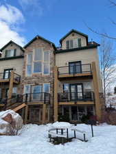 View of snow covered rear of property