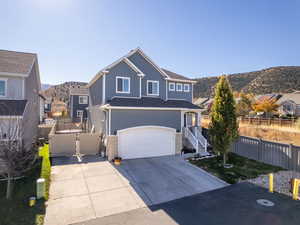 View of front property with a garage and a mountain view