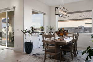 Dining room featuring light hardwood / wood-style floors, an inviting chandelier, and plenty of natural light