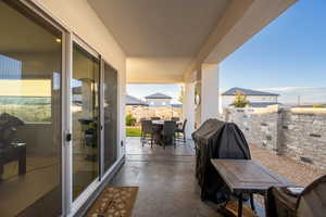 Balcony with area for grilling and a patio