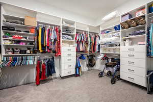 Spacious closet with carpet floors