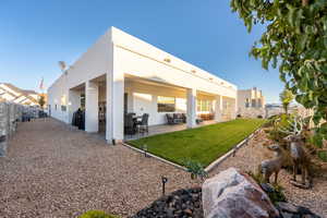 Rear view of property featuring an outdoor hangout area, a patio area, and a lawn