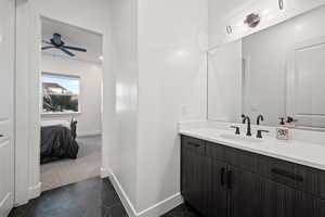 Bathroom with tile patterned flooring, vanity, and ceiling fan