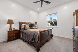 Bedroom with light colored carpet and ceiling fan