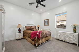 Carpeted bedroom with ceiling fan