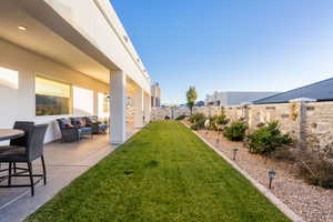 View of yard with outdoor lounge area and a patio