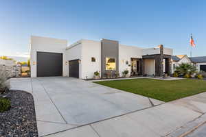 Contemporary home featuring a garage and a front yard