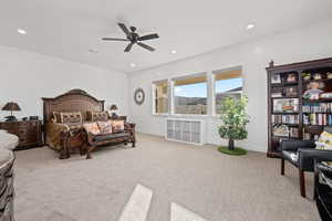 Carpeted bedroom with ceiling fan