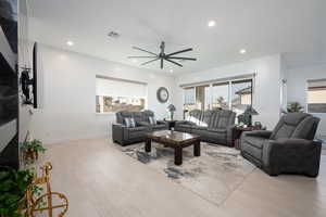 Living room featuring light hardwood / wood-style floors and ceiling fan