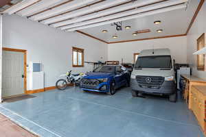 Garage with electric panel and a garage door opener