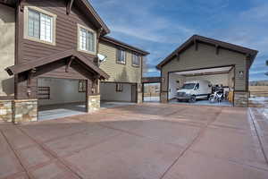 View of front of house featuring an outbuilding and a garage