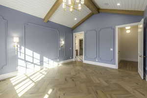 Unfurnished room with beam ceiling, light parquet flooring, high vaulted ceiling, and an inviting chandelier