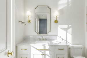 Bathroom featuring vanity and toilet