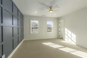 Spare room with ceiling fan and light carpet