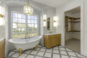 Bathroom with a bathing tub, vanity, and tile walls