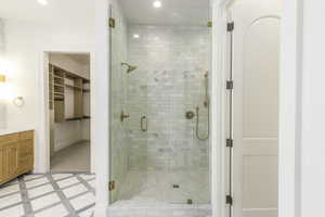 Bathroom featuring vanity and an enclosed shower