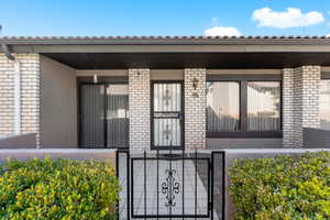 Doorway to property with covered porch