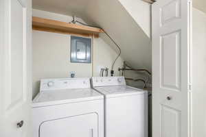 Laundry area featuring electric panel and washer and dryer