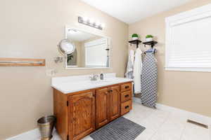 Bathroom with vanity and tile patterned floors