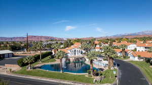 Drone / aerial view of clubhouse and one of many community ponds.  Also featuring a mountain view