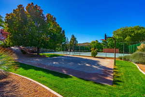 View of basketball court with pickleball court and a lawn