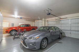 Garage featuring electric panel and a garage door opener