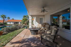 View of patio featuring a fire pit and ceiling fan