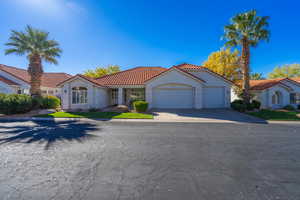 Mediterranean / spanish-style home with a garage