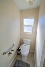 Bathroom featuring tile patterned floors and toilet