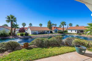 View of back yard and pond