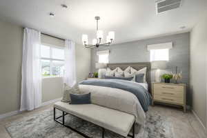 Bedroom with an inviting chandelier, light carpet, and a textured ceiling