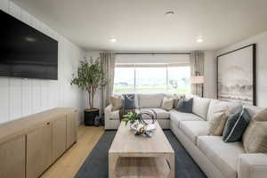 Living room featuring light hardwood / wood-style floors and a textured ceiling