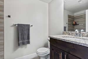 Bathroom featuring vanity and toilet