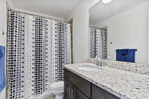 Bathroom featuring vanity and toilet