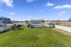 View of yard featuring a playground and an outbuilding