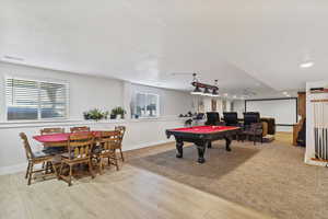 Recreation room with billiards, a wealth of natural light, and light hardwood / wood-style flooring