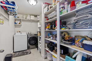 Laundry room featuring light tile patterned floors and washer and dryer