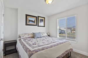 Bedroom featuring dark carpet