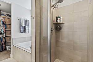 Bathroom featuring tile patterned floors and plus walk in shower