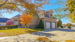 View of front property with a front yard and a garage