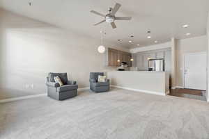 Sitting room with light carpet and ceiling fan