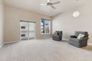 Sitting room featuring light carpet and ceiling fan