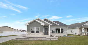 Craftsman house with a front lawn