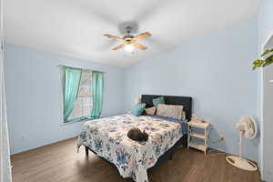 Bedroom featuring hardwood / wood-style flooring and ceiling fan