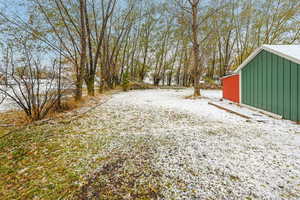 Snowy yard with an outdoor structure